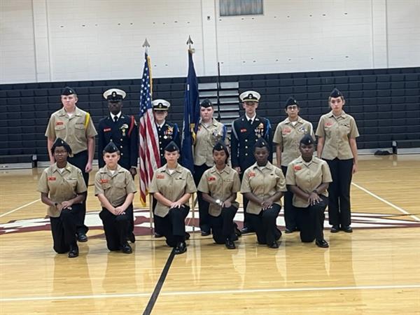 Military students posing with uniform at gym 