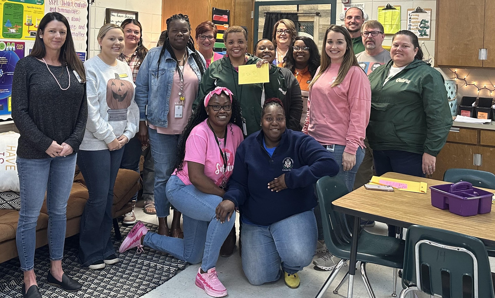 Group of middle school staff celebrating principal