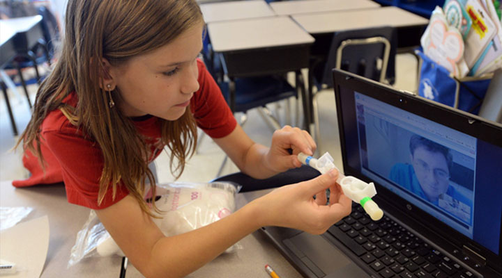 girl student doing an activity with her laptop