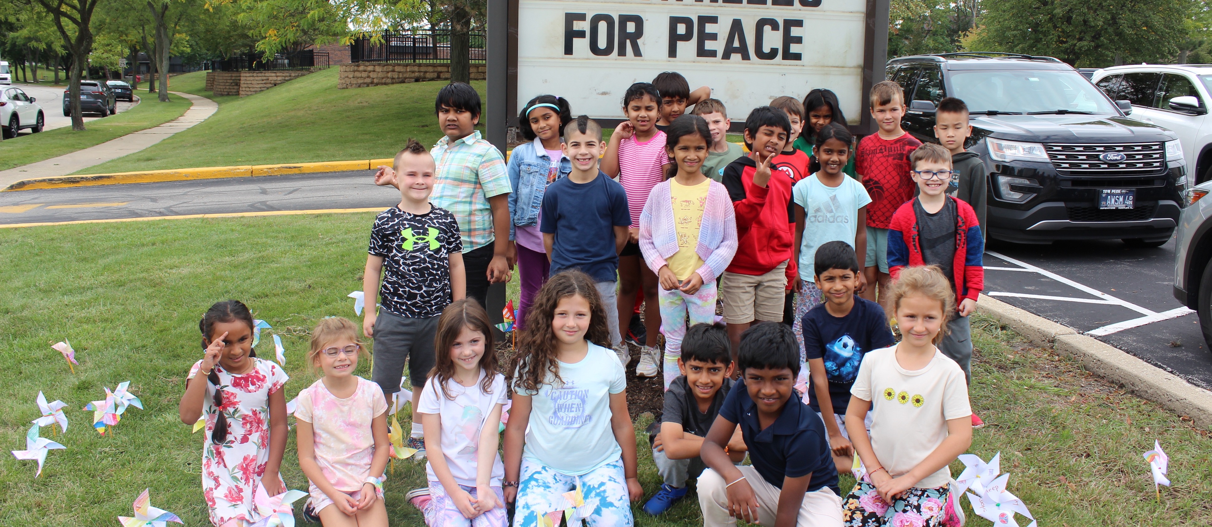 A class at Pritchett poses in front of their sign outside