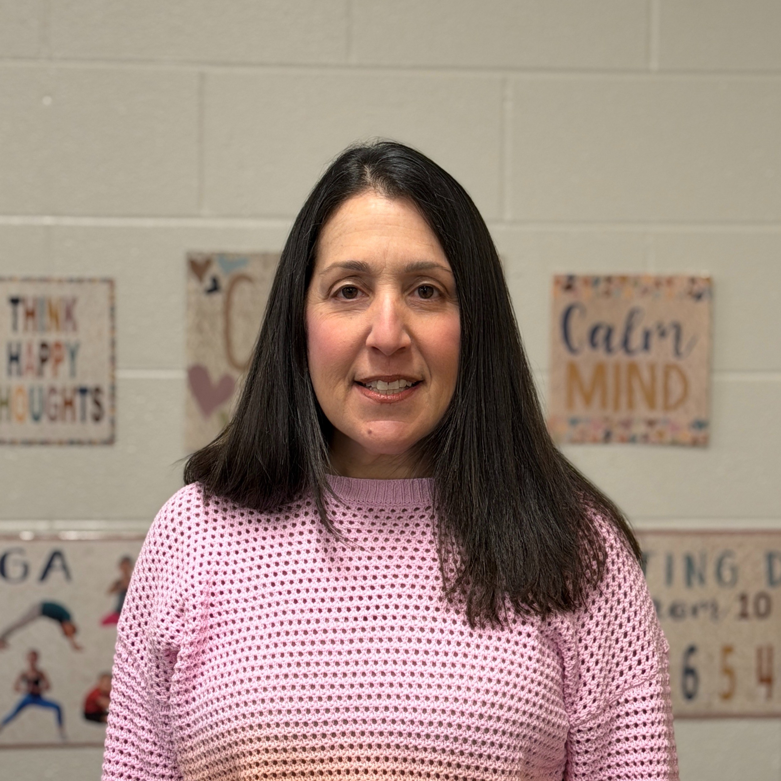 Mrs. Goldwin headshot, standing in front of a white wall.