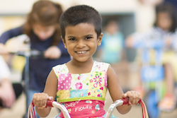 boy holding an object in each hand 