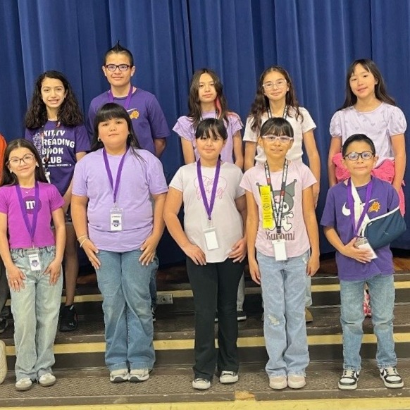 Group of student ambassadors posing on stage