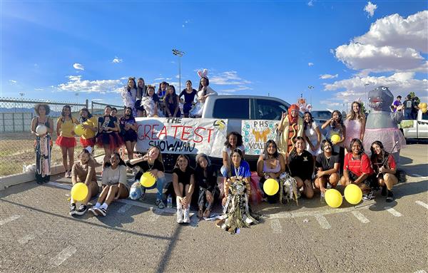 volleyball team posing for a picture with a sign