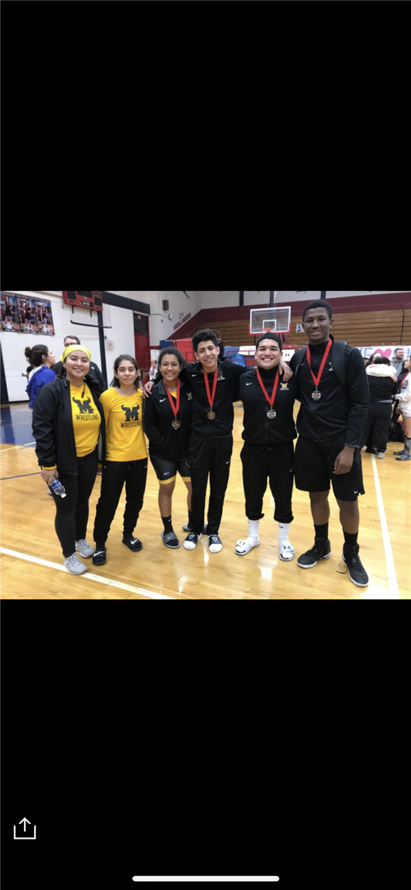 wrestling members showing their medals