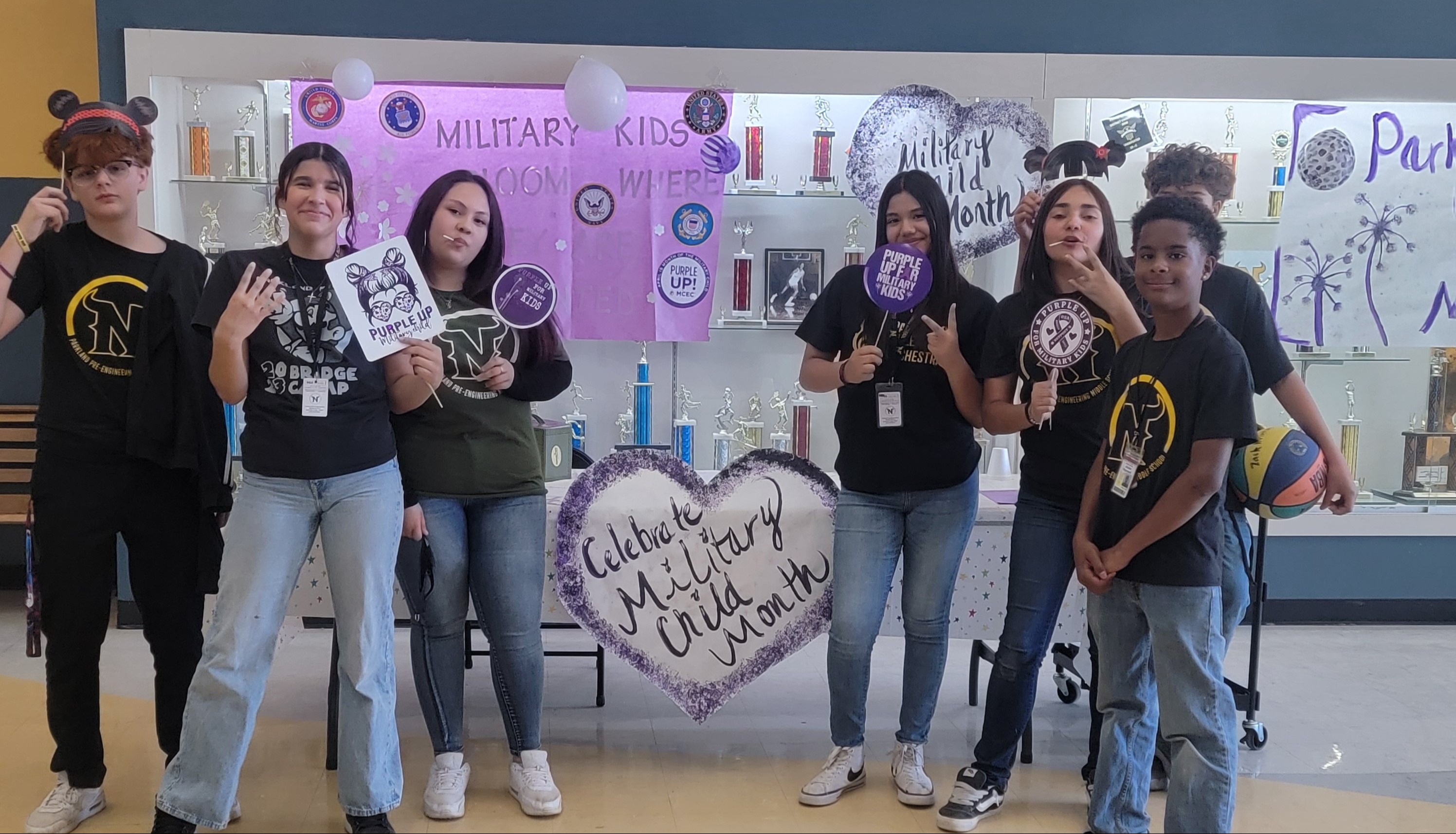 Celebrate Military Child Month picture of students holding up signs that celebrate the ocassion
