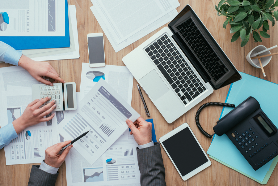 a photo of a desk at which people are working