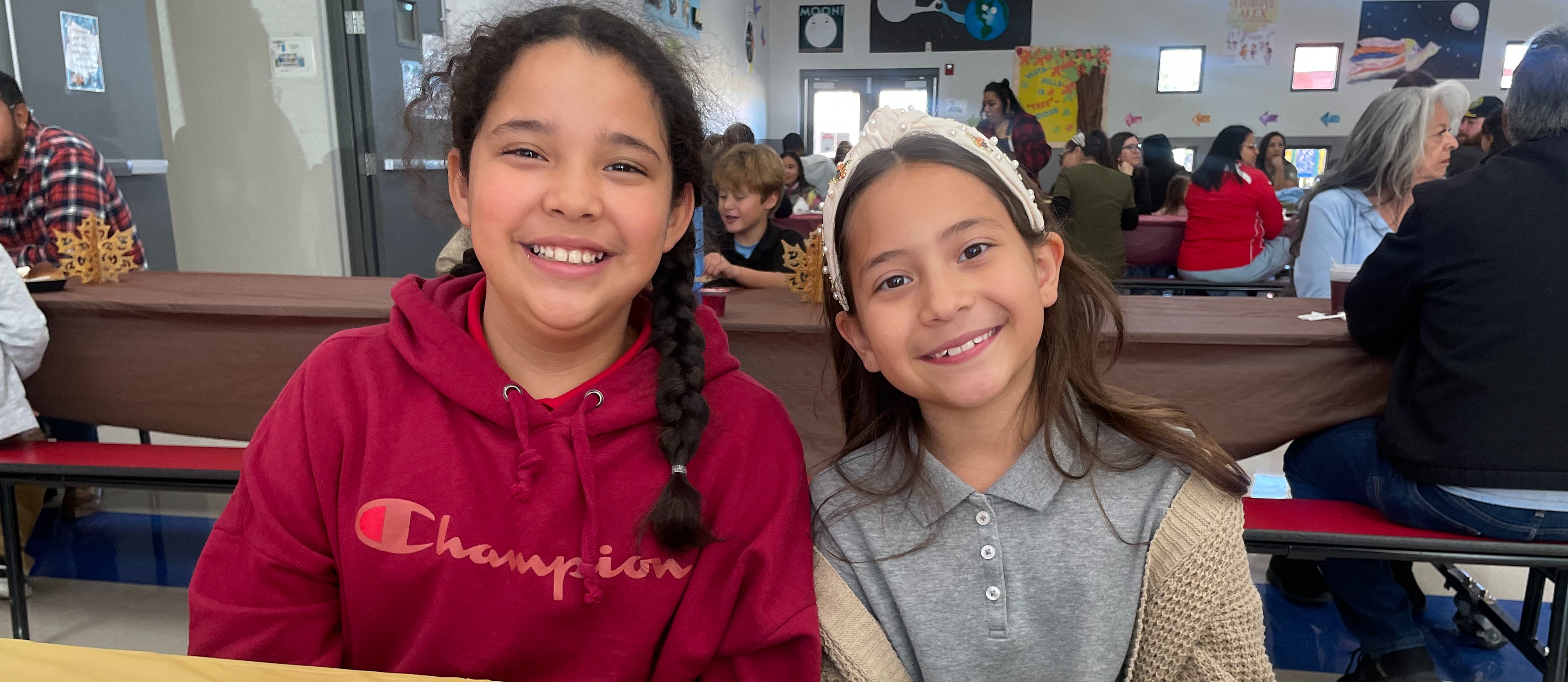 2  young students smiling with their thanksgiving lunch