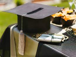 graduation cap with diploma on a table