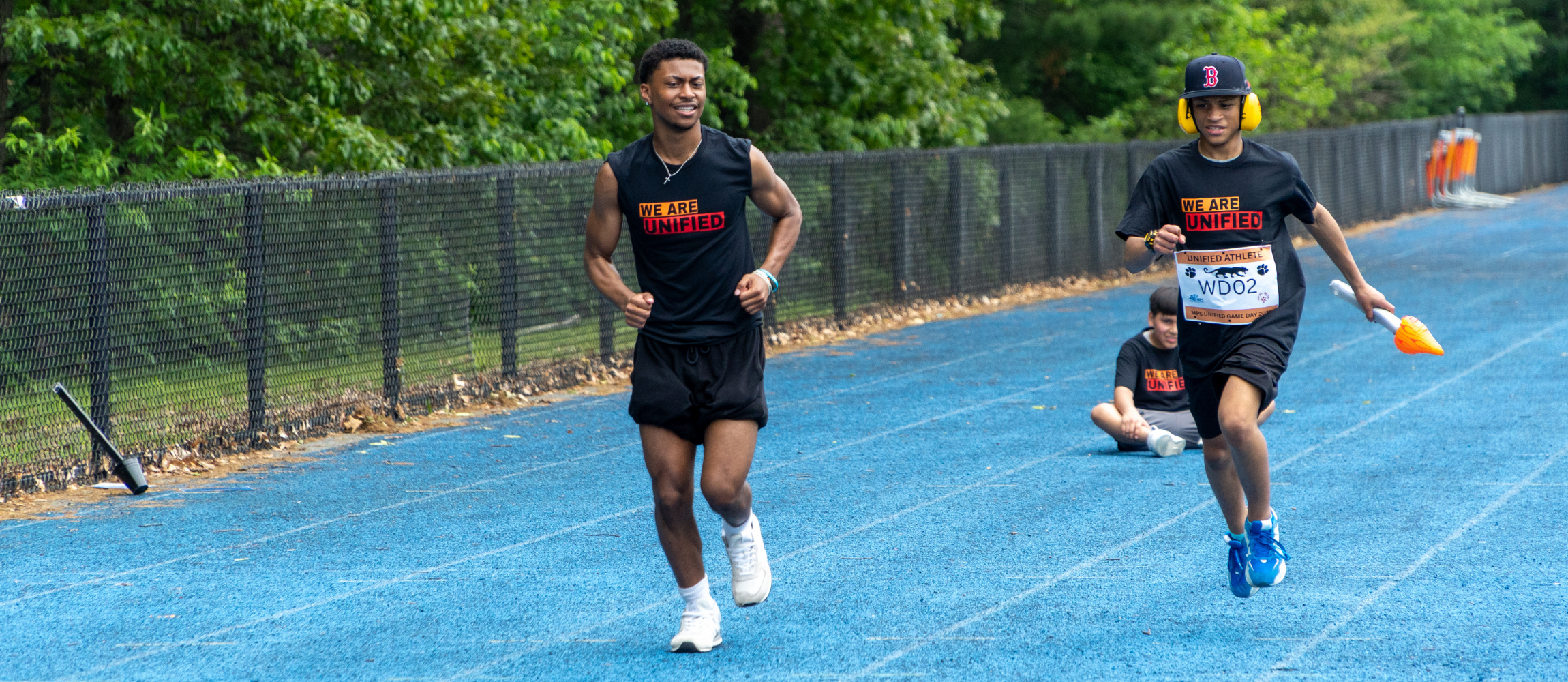 Two students race on the track during the 2025 Unified Game Day.