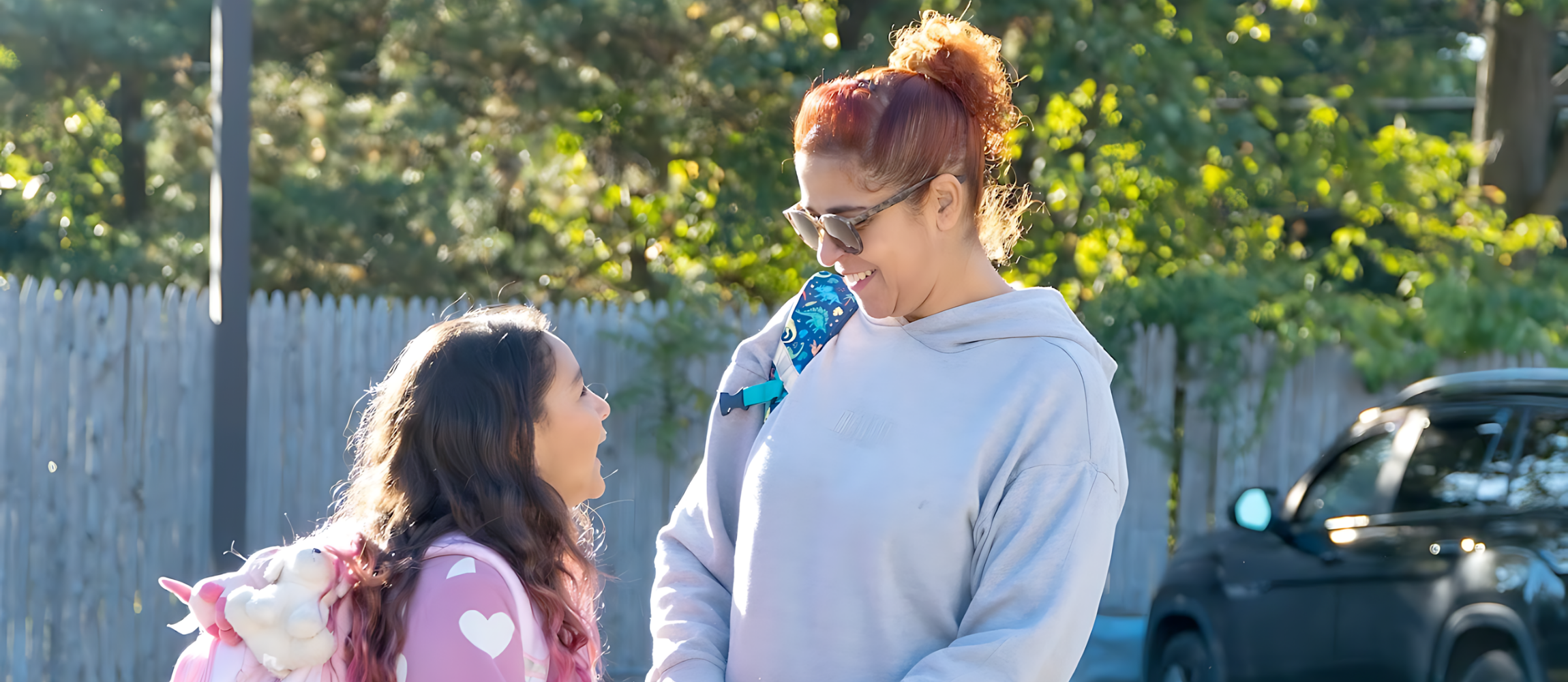 A Richer School student and her mom stand and talk outside.