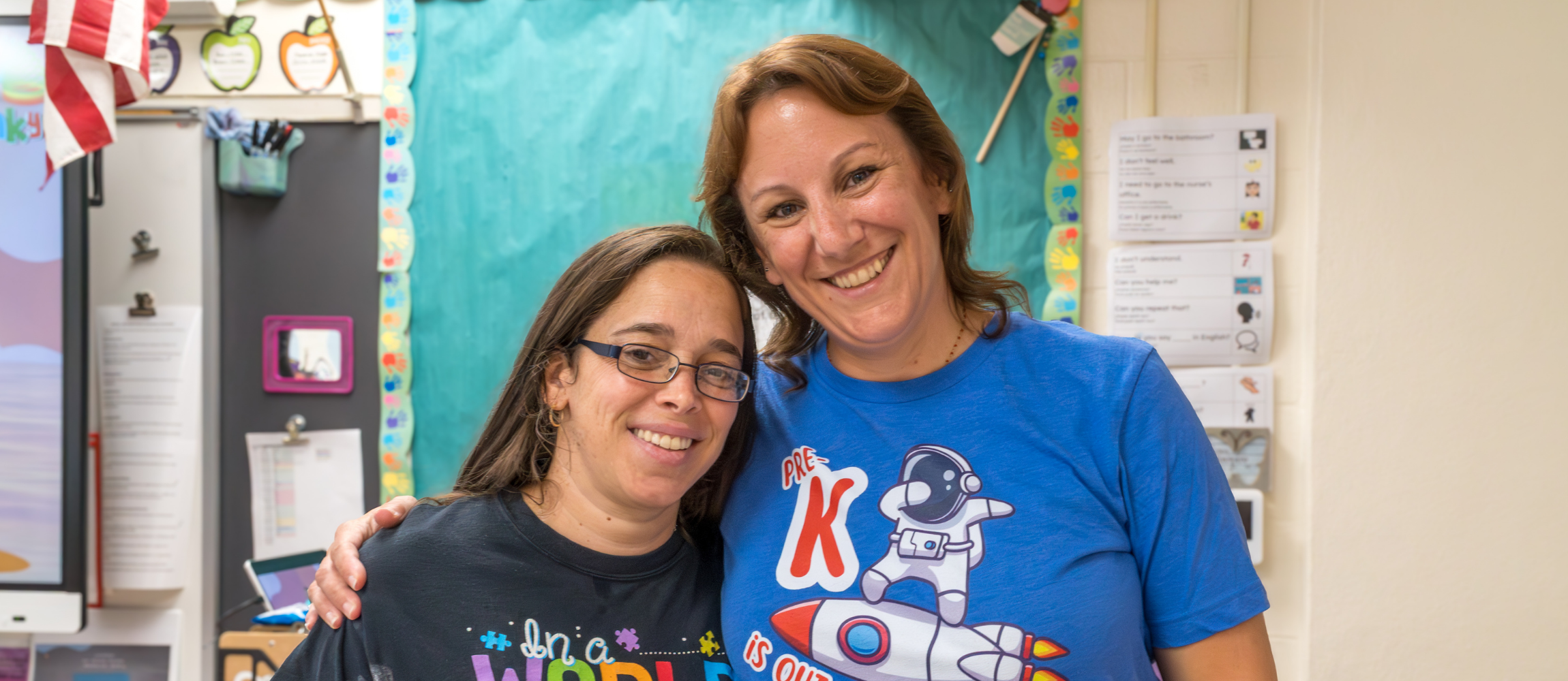 Two ECC teachers pose for a group photo.