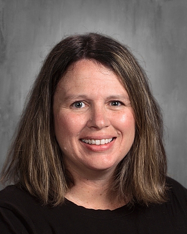 A lady with short black hair wearing black shirt.