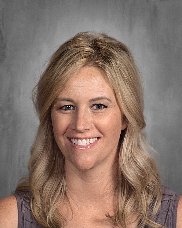 A lady with long blonde hair smiling.