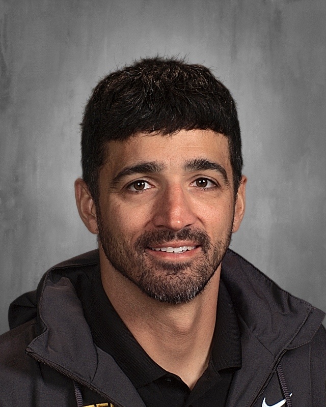 A bearded guy wearing a sweater.