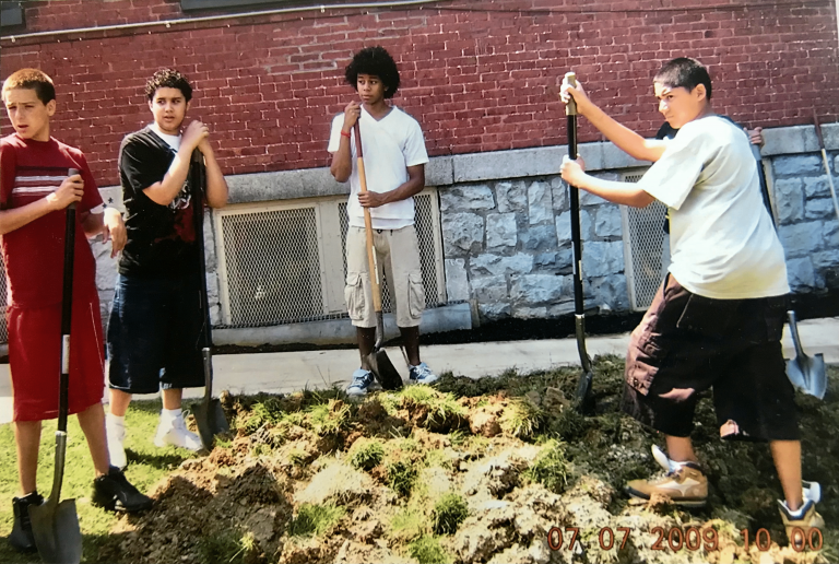 Teens shoveling dirt