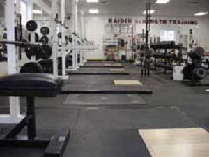 School gym with multiple pieces of workout equipment 