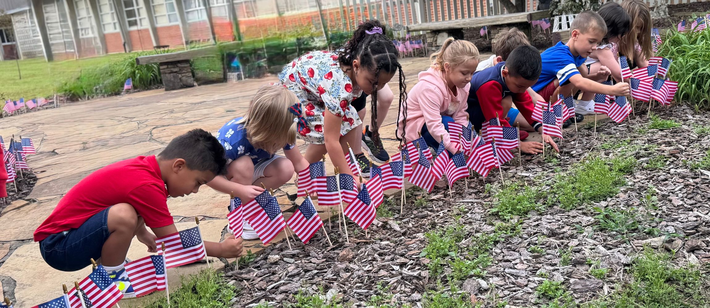 911 ceremony and students put flags in Sandy's Garden 
