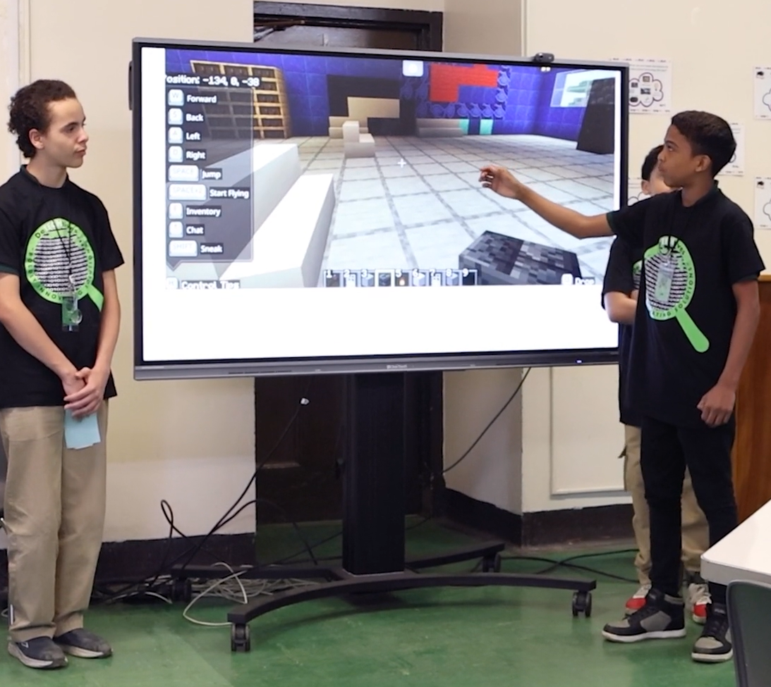 Boy explaining minecraft on a digital display