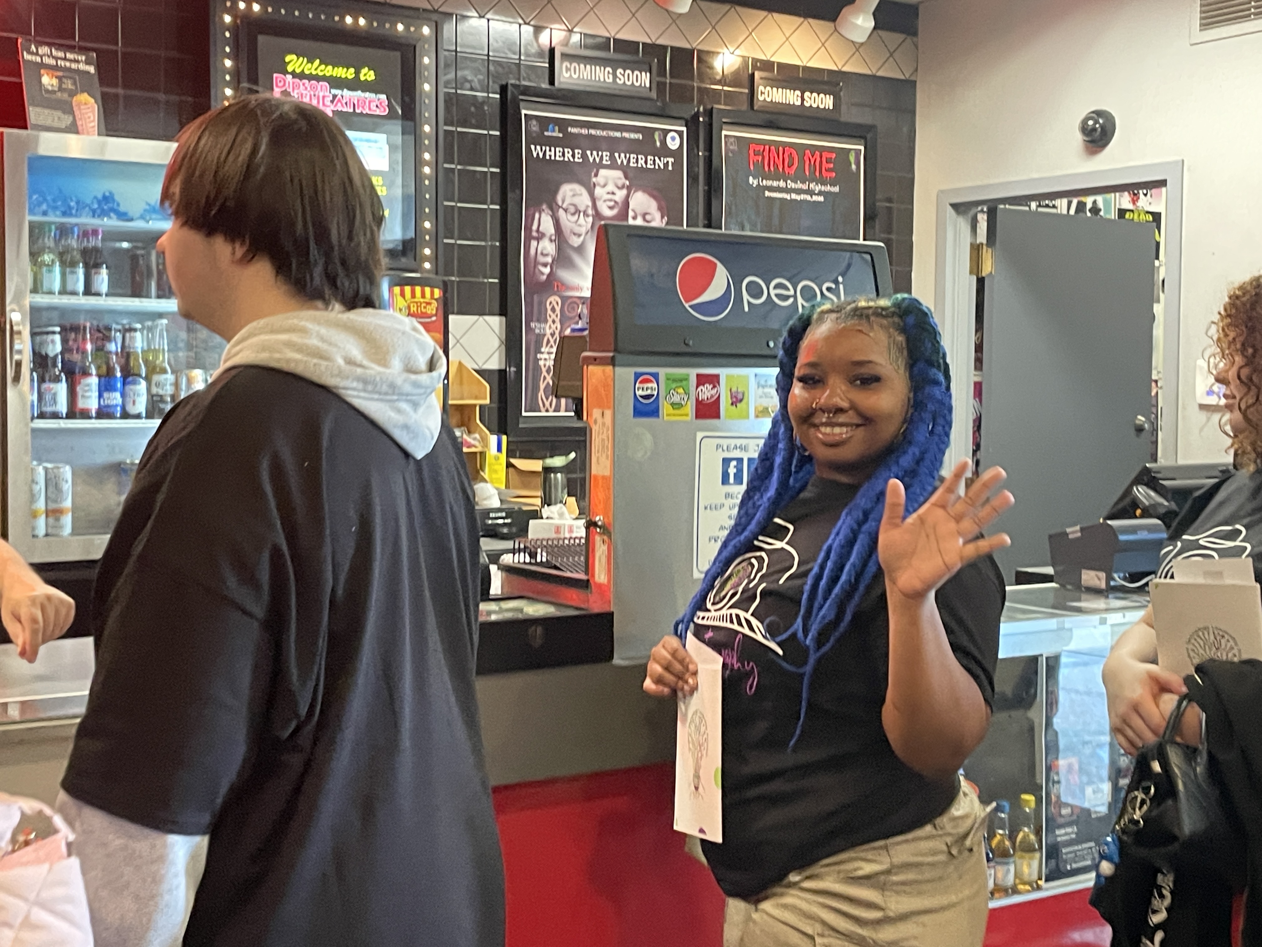 student waving at concession stand