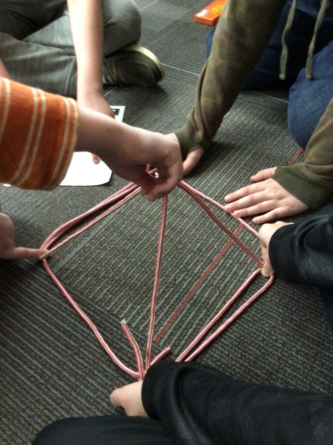 students creating polyhedra with a length of rope