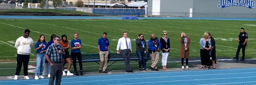Students and teachers on a football field