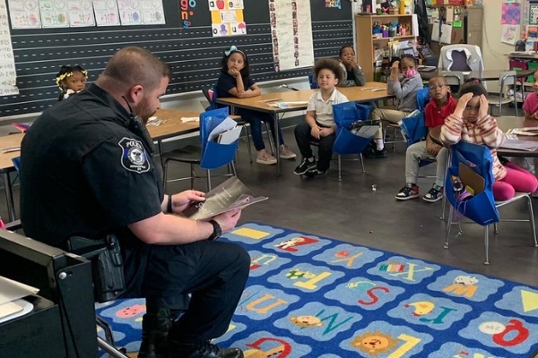 Officer reads to a classroom