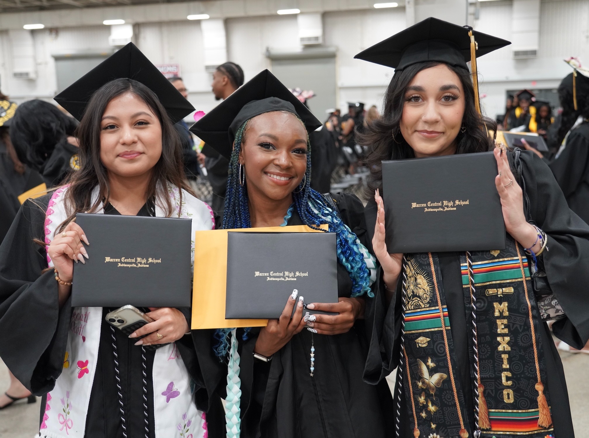 Girls posing for a picture in their graduation gowns