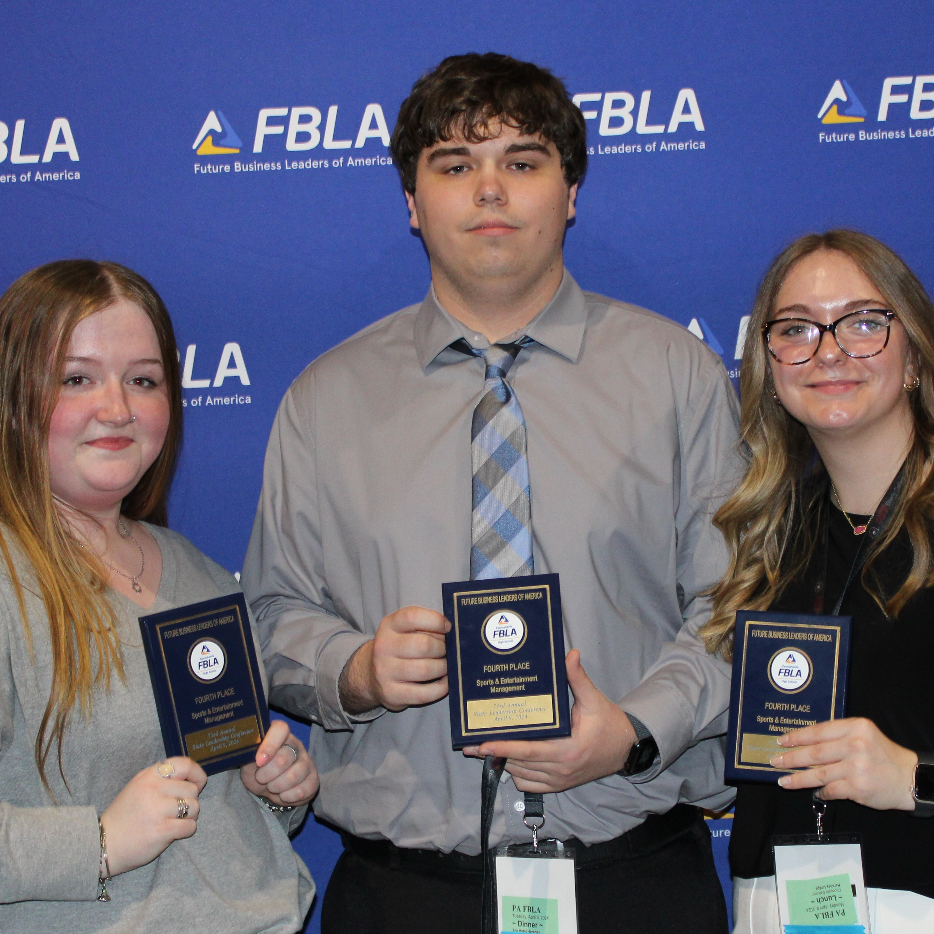 three girls holding FBLA trophies