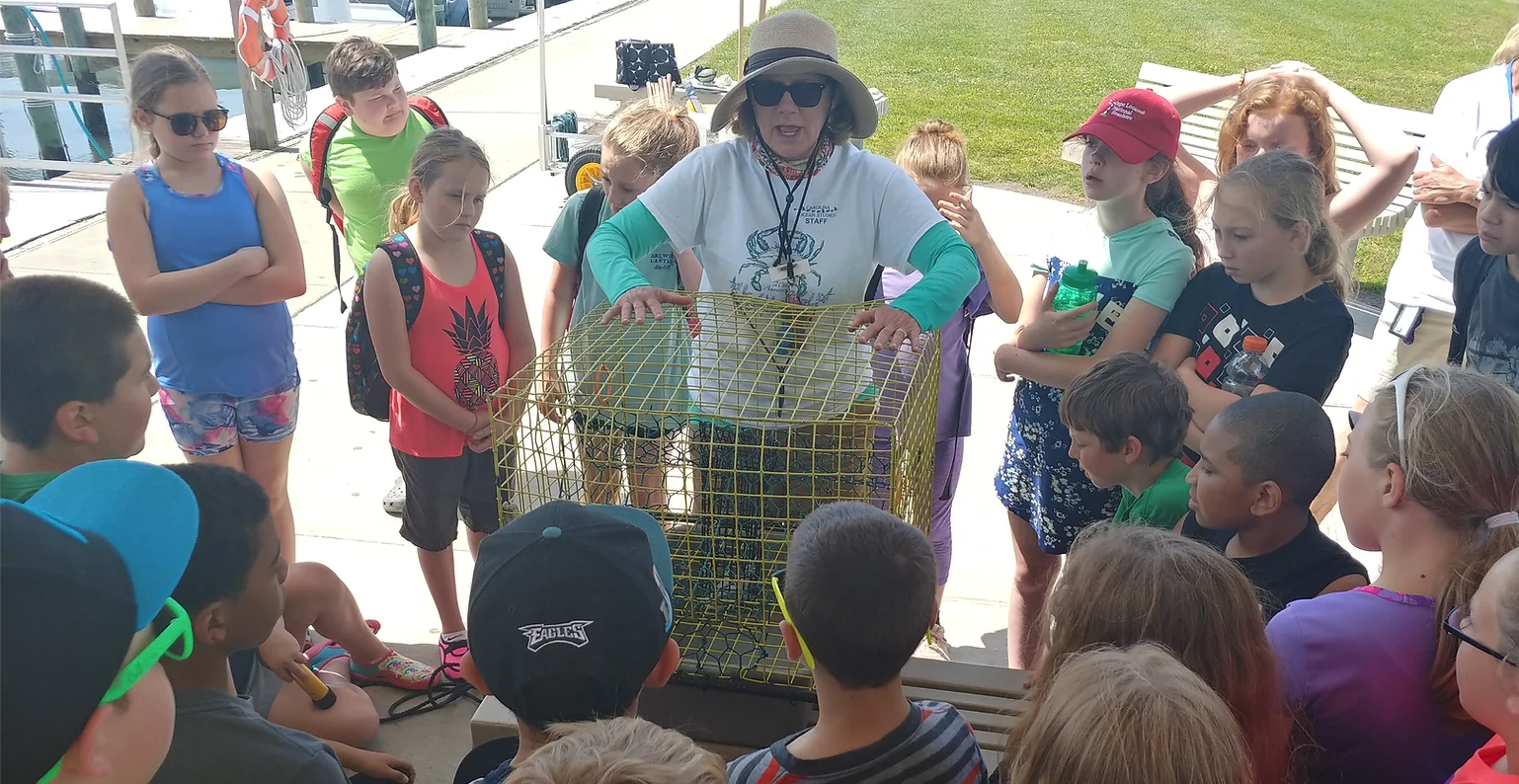 teacher showing to students cage