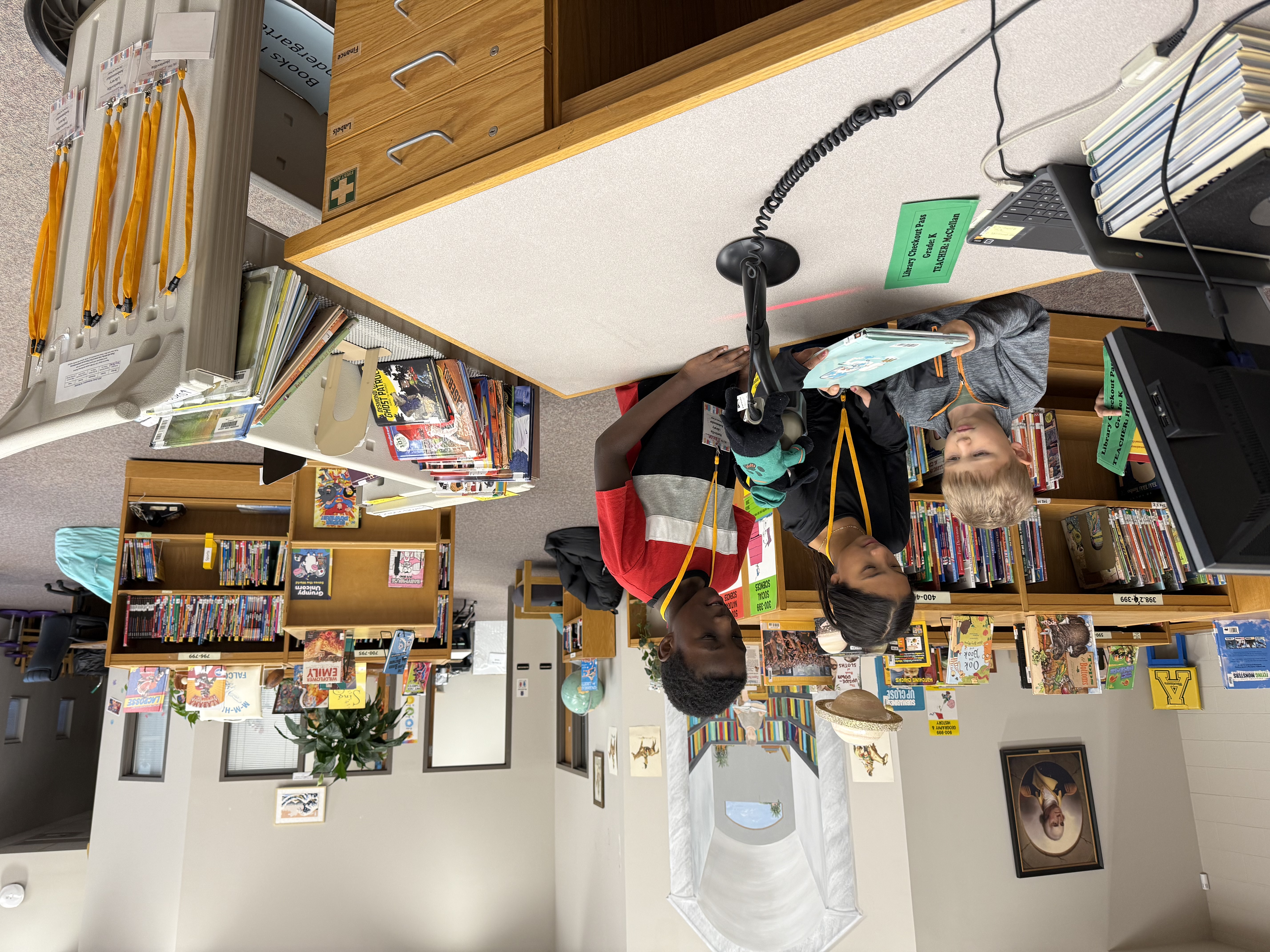 student helping another student checkin book