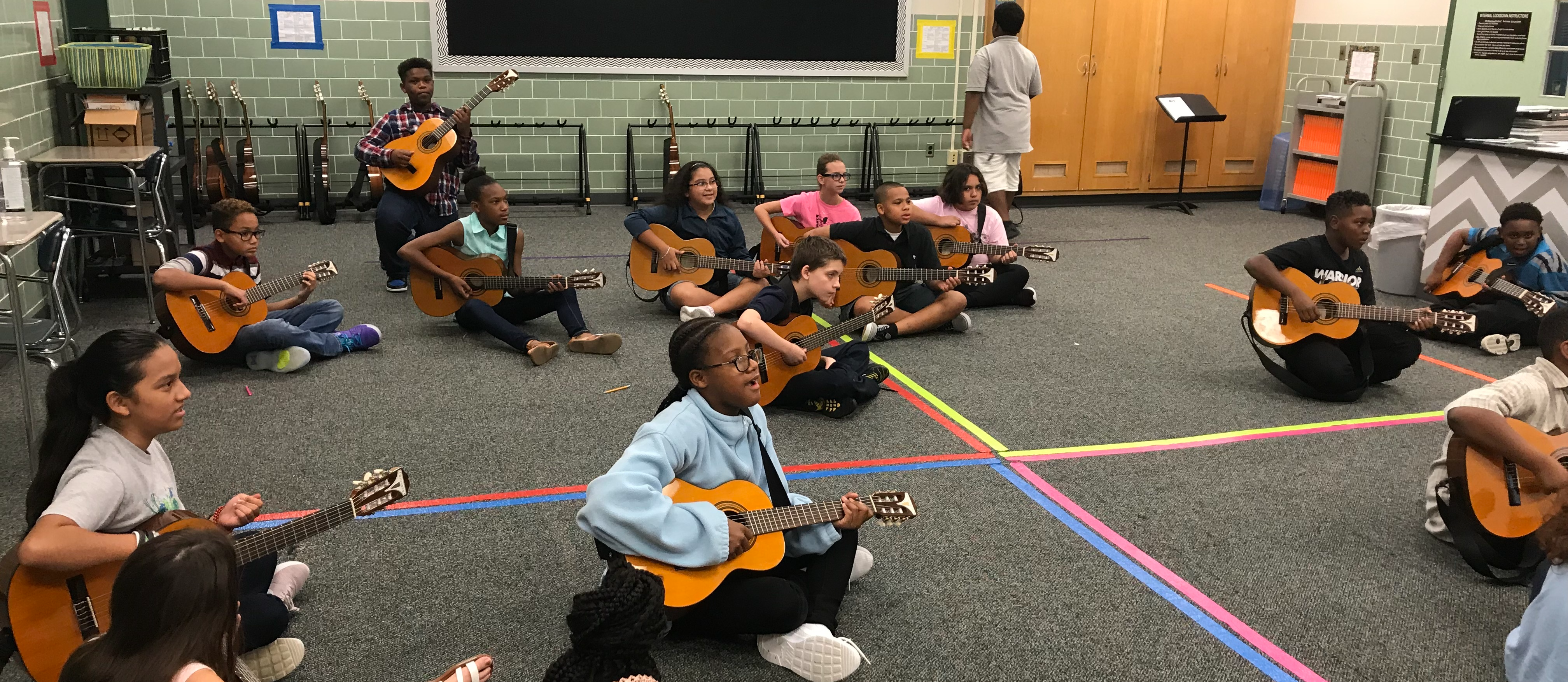 students playing guitars
