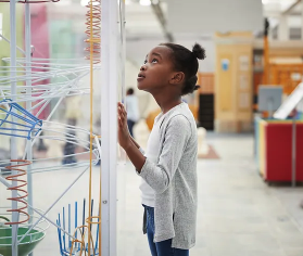 girl watching a class toy