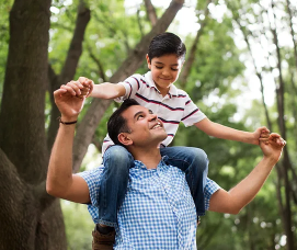 dad carrying his son on his shoulders