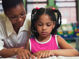 teacher helping a student reading