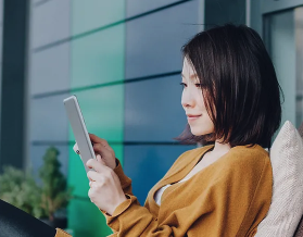 woman laying down on her phone