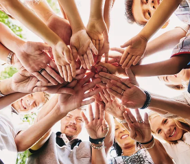 students joining hands together