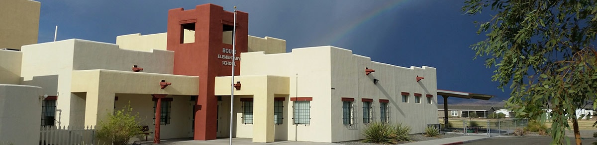 Outside of Bouse Elementary School building with rainbow in background