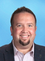 A professional man wearing a suit and tie with a pleasant expression on his face.