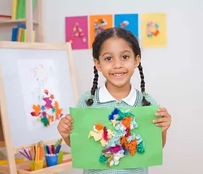 little female student holding an art piece made by herself