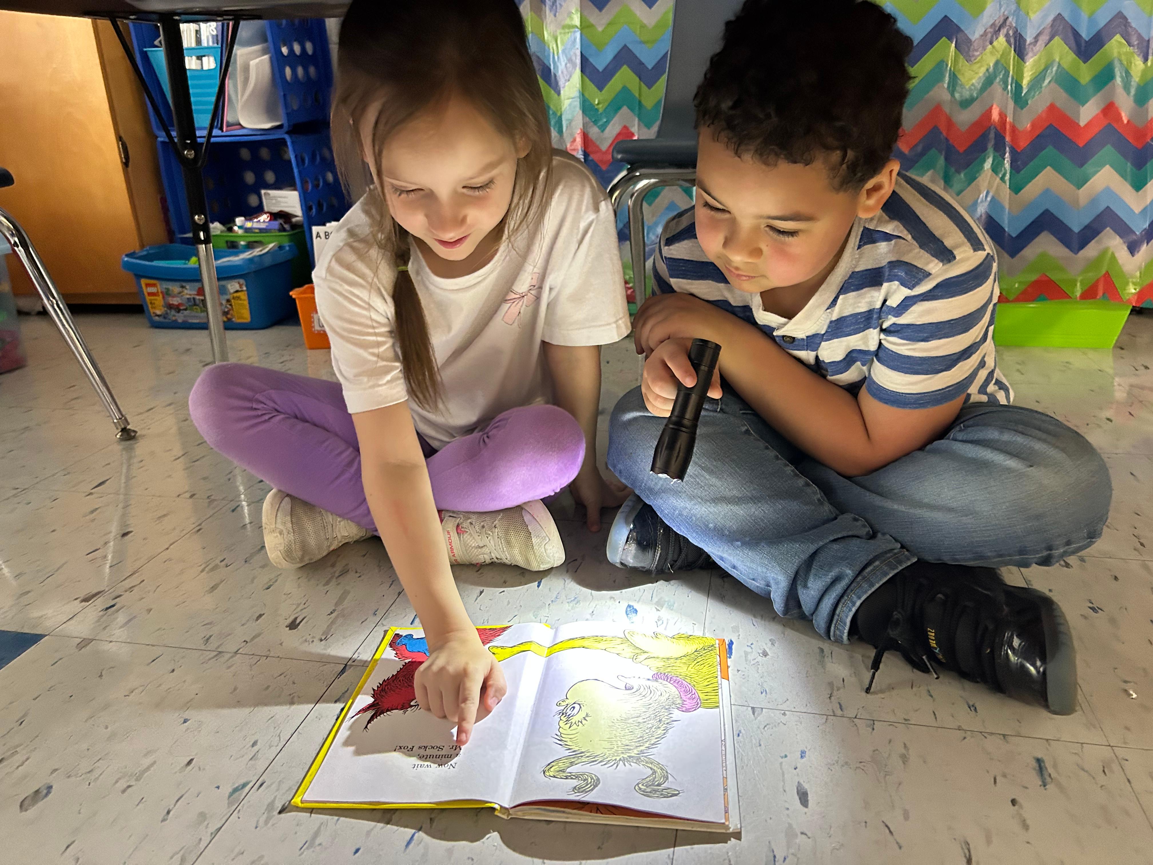 Students reading with a flashlight for Read a Thon