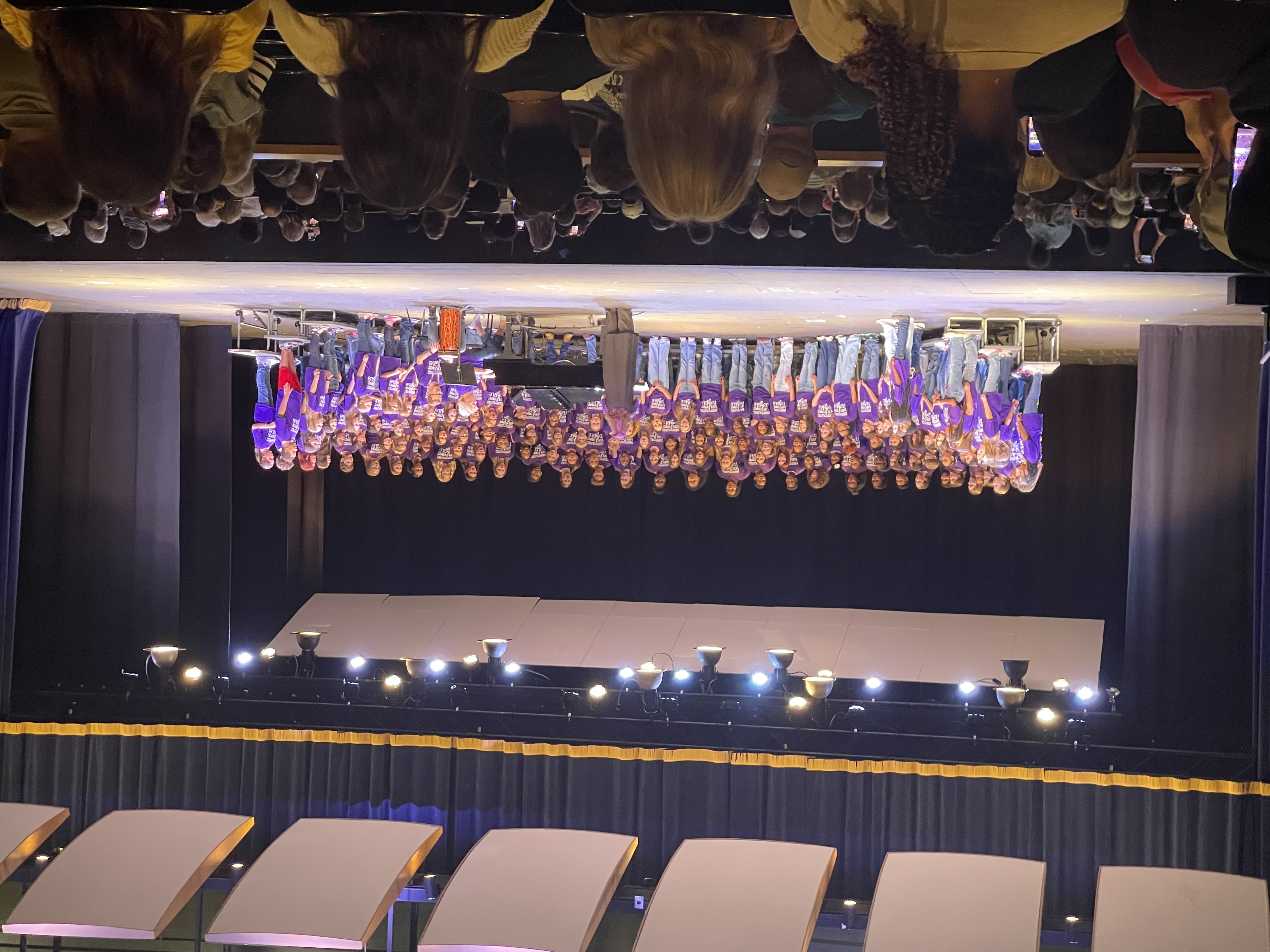 The entire choral group performing on a stage for the All County Chorus program