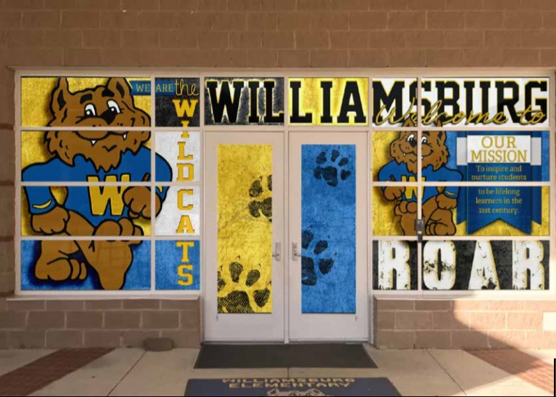 A picture of the front entrance of the school decorated with the school mascot and school colors.  