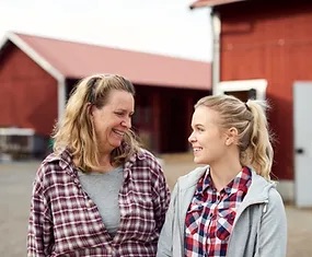 mother and daugther talking and smiling at each other