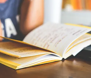 student reading a notebook