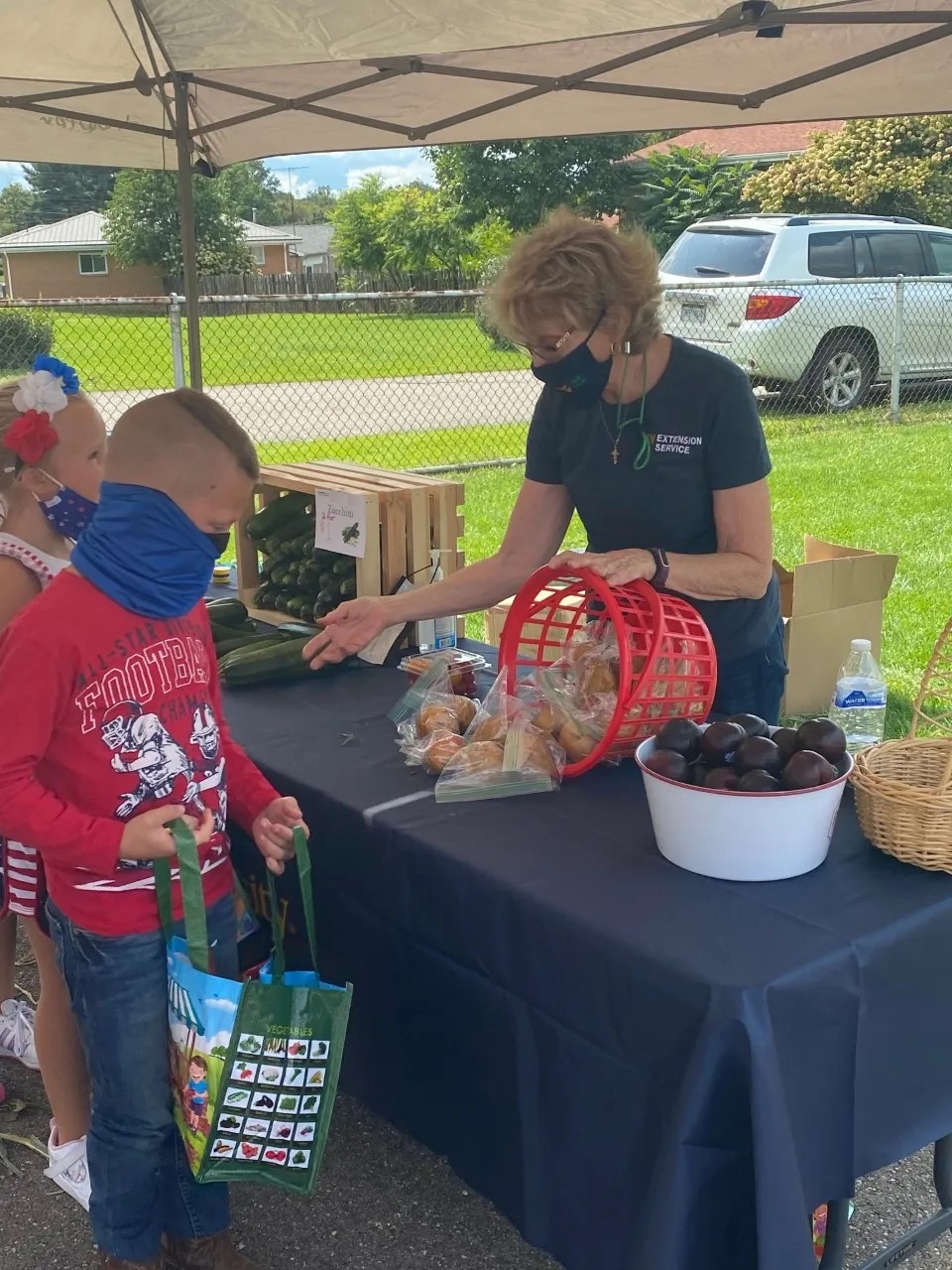 The woman giving a candies to a boy