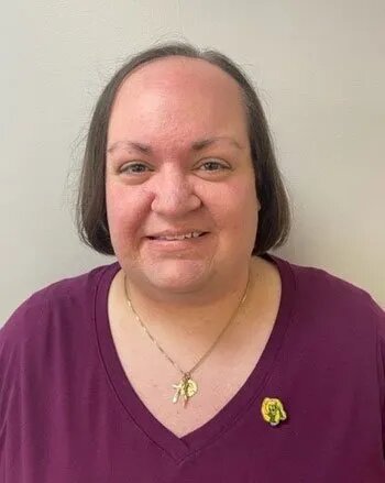 an image of a woman wearing a maroon shirt