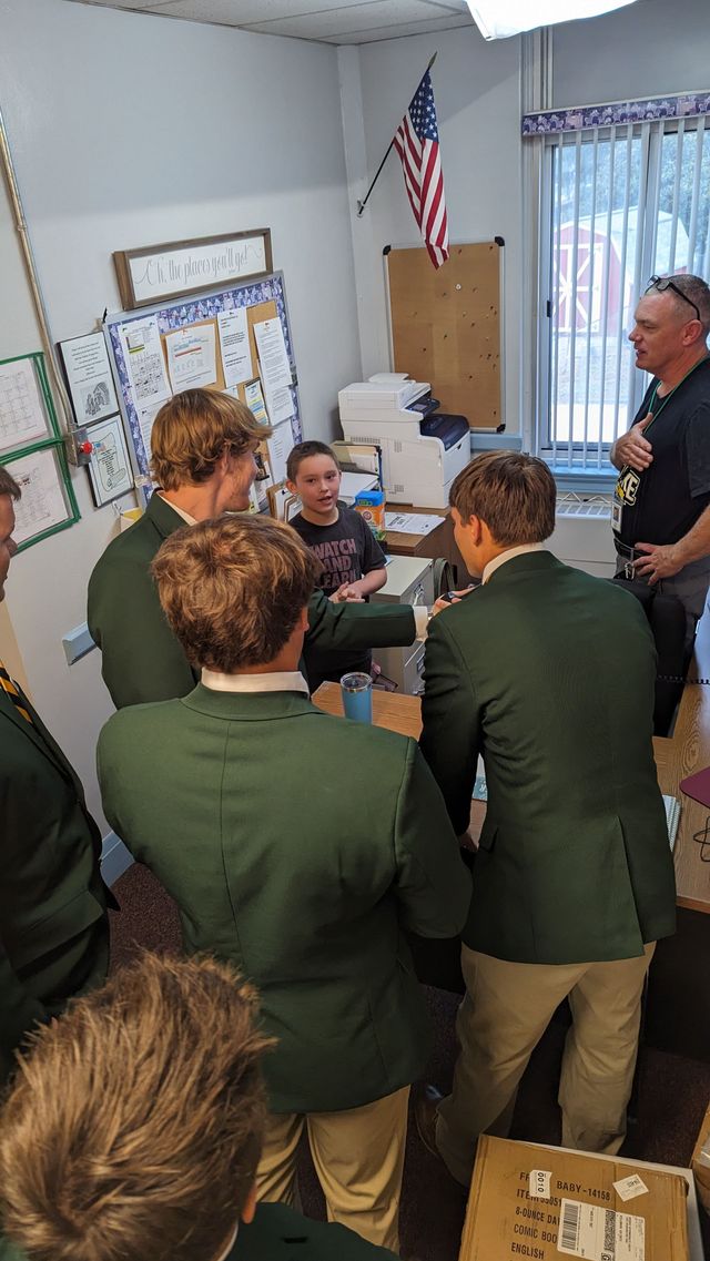 Group of students meeting and greeting some of the younger students.