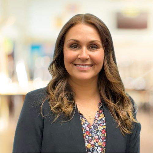 face white woman brown hair gray blazer in classroom