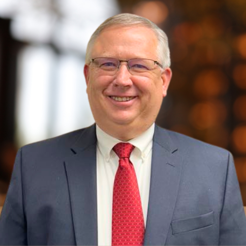 face white male gray hair glasses gray suit red tie